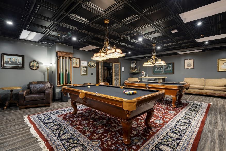 Large game room with billiards and lounge furniture