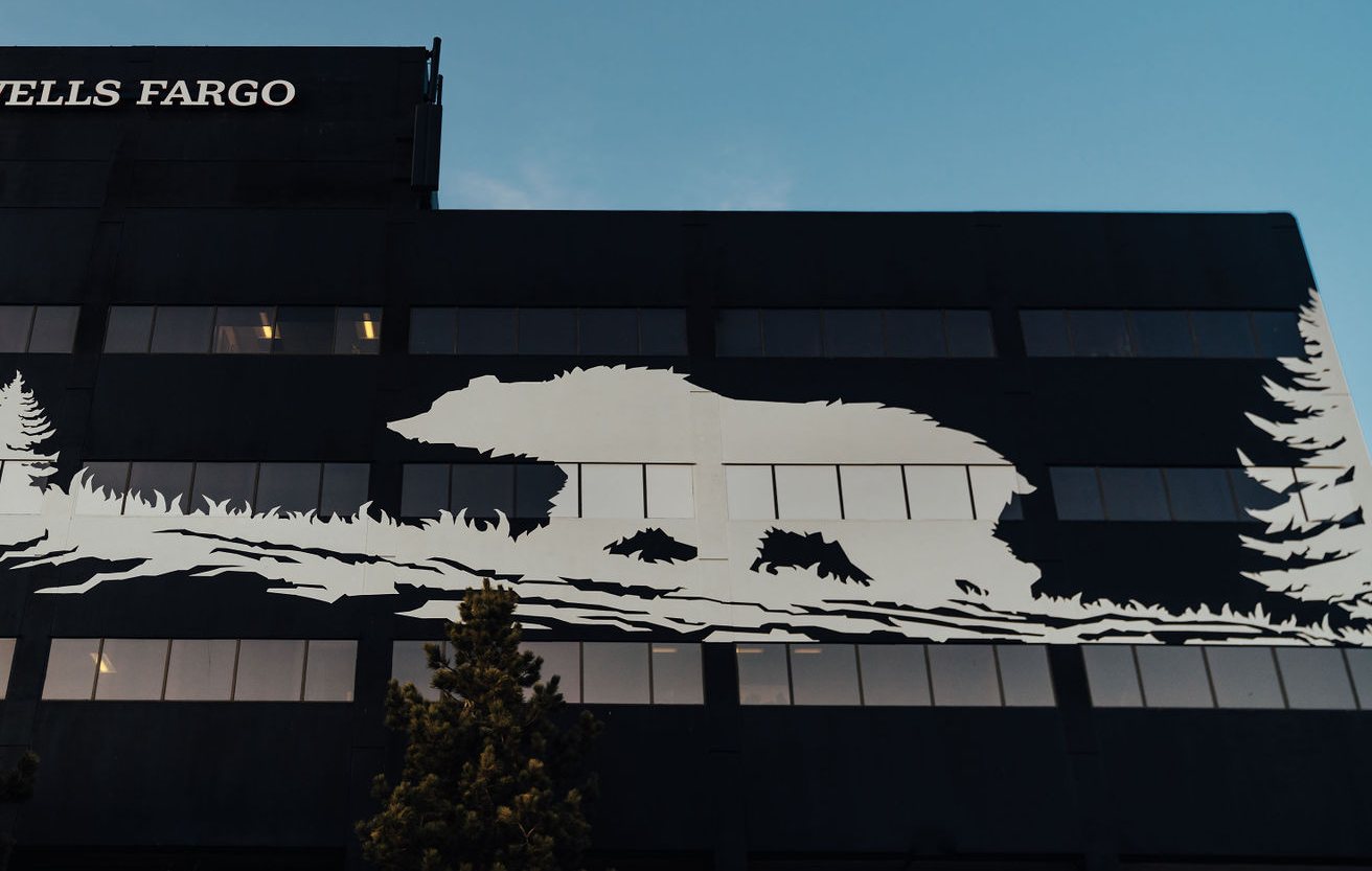 Bear and pine mural spanning the Bear Valley Center façade