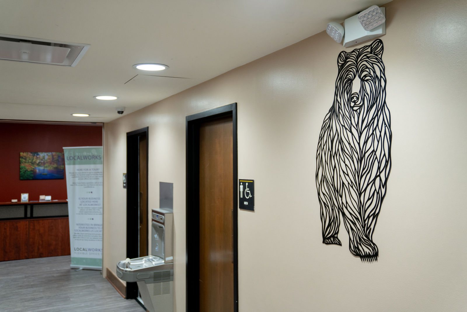 Metal bear artwork beside a corridor doorway