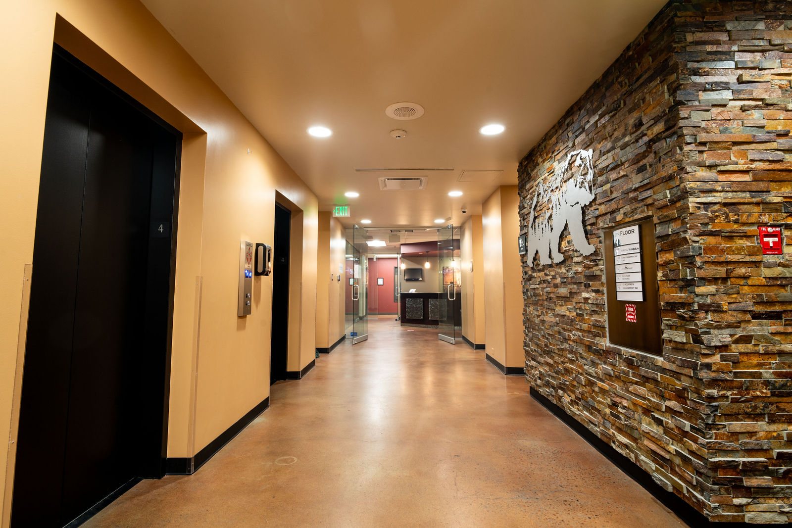 Corridor lined with stacked stone and bear artwork