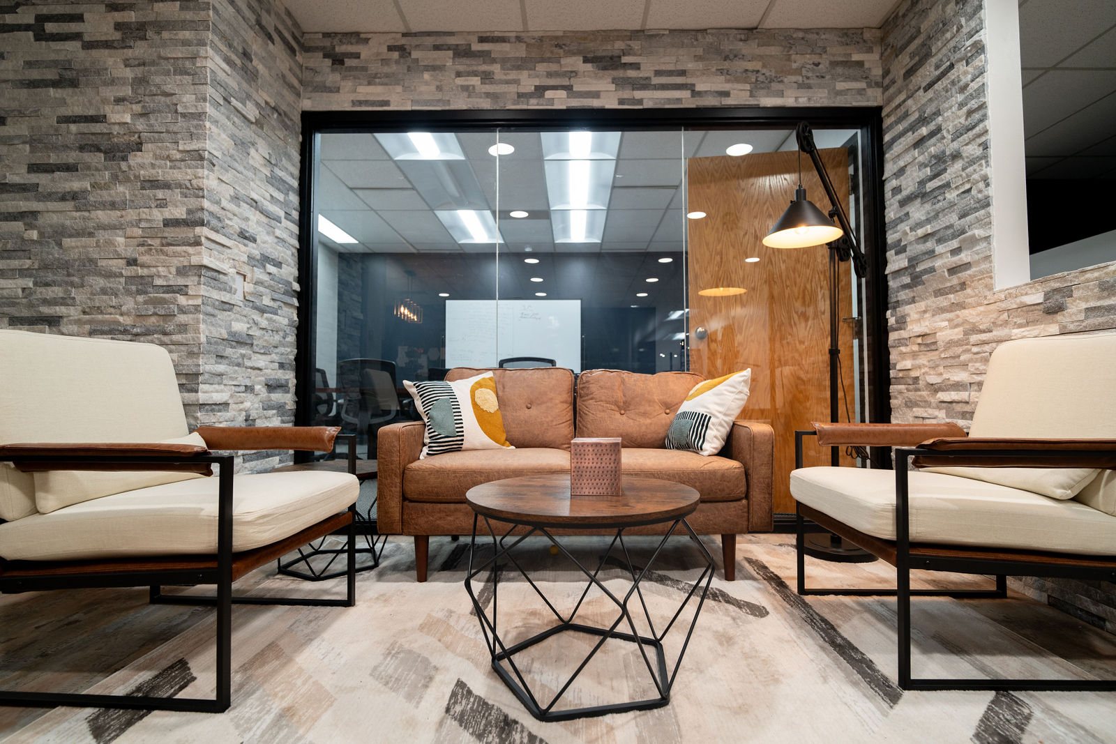 Lounge seating framed by stone walls and glass