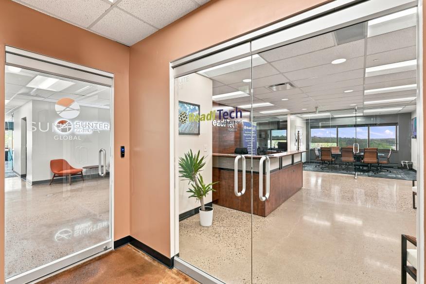Glass-front private office and daylit corridor at Bear Valley Center