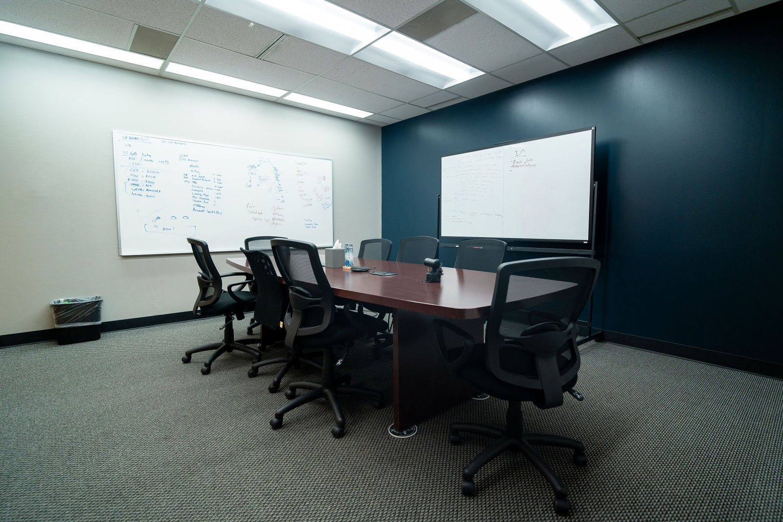 Boardroom with whiteboards and a long table